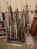 Assorted garden tools- scoop shovels, sledge hammer, post driver, snow shovels and more