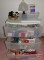 Sterilite 3 drawer plastic organizer with household items: light bulbs, spray bottles,