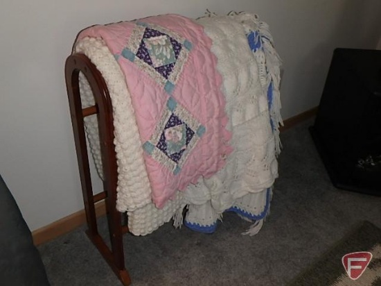 Wood quilt rack with afghans and quilted table runner