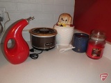 Rival small crock pot, biscuit jar, Rachel Ray oil cruet, candles, silverware utensils, plastic