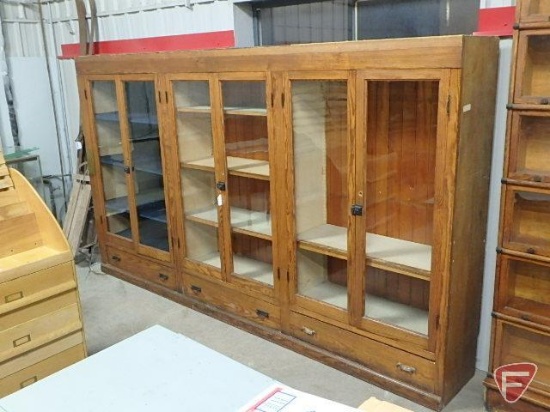 Wood display case with 6 glass doors, 3 drawers, adjustable shelves. One piece unit.