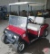 EZ-GO electric 2-seat red golf car with headlights, canopy, windshield, horn, model D2093