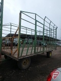 9 X 16 metal bale throw rack on John Deere 1065A wagon with flotation tires, extension pole