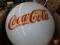 Metal enamel half globe with Coca-Cola insignia, Coca-Cola glasses, and other related Coke items