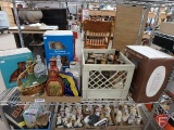 Assortment of decanters, wildlife, souvenir, Beams Choice. All on shelf on metal cart.