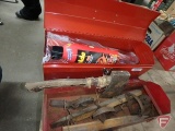 Red metal tool boxes with animal traps, both