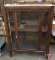 Vintage wood/glass display cabinet with one door, lighted, missing one shelf, 64inHx48inWx16inD
