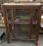 Vintage wood/glass display cabinet with one door, lighted, missing one shelf, 64inHx48inWx16inD