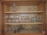 Glassware (3 shelves) including juice pitcher, candle holders, wine classes, water glasses,