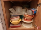 Drawer with kitchen utensils and cupboard with Tupperware and other plastics
