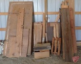 Assortment of wood planks, plywood sheets, and other pieces