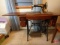 Singer sewing machine on treadle base with cabinet and accessories