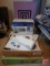 Brother Innovis NX-250 sewing machine with accessories, magnifying glass, and cutting board