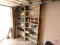 Contents of shelf: Milwaukee sawzall blades, combination wrenches, hammer,