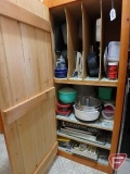 Contents of cupboard: baking pans, cake decorating tools, containers, trays, enamel roasters,
