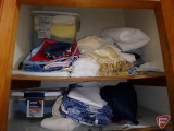 Contents of top 2 shelves: towels, linens, and table cloths