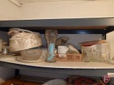Clear glass stemware, glasses, ceramic plates, serving platters, Corelle dishes, and