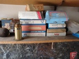 Contents of shelf: ignition wire sets, oiler, antifreeze tester, wire, light head magnifying glass,