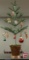 Feather looking artificial tree 35inH with 12 vintage ornaments. Most are Santas