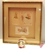 Framed and matted kewpie doll print 17inHx16inW and Kewpie doll in glass paperweight. 2 pieces