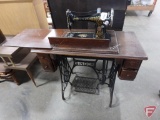 Singer treadle sewing machine in wood cabinet