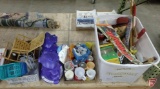 Toys, Tonka dump truck, dolls, plush toy, Fred Flintstone fruit snack container, doll stands,