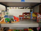 Fisher Price House, Merry Go Round, and Sesame Street Clubhouse, with accessories.