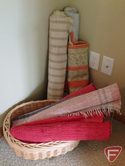 Assortment of throw rugs and wicker basket