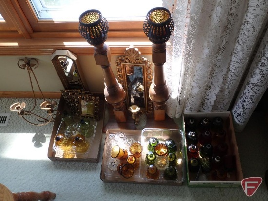 Collection of votive candle cups and decorative holders and framed mirrors.
