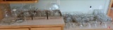 Clear glass items, glasses, stemware, sundae cups, butter dish, bowls, candle holders vases, bell,