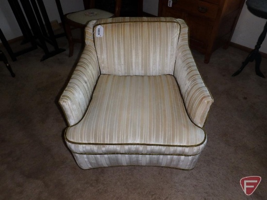 Upholstered chair on wheels, swivels
