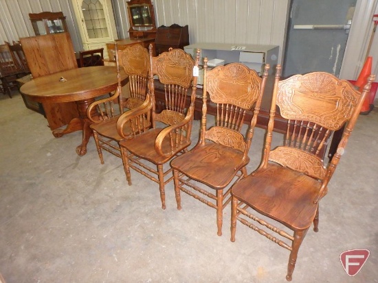Wood 48in round pedestal table with (1) 24in leaf, and (4) matching wood chairs, 2 with arms.