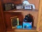 Transistor radios, Kodak camera, Keystone camera. Contents of bottom 2 shelves