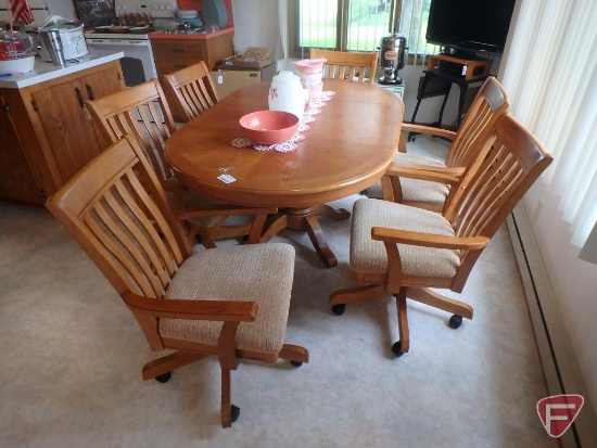 Wood pedestal table, made in Malaysia, six chairs with arms on casters