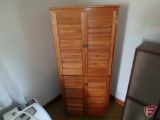 Wood closet on rollers with wood dowels inside, possible hanger for linens/slacks