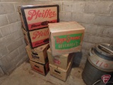 Cardboard cases with empty beer bottles, Miller, Rock Spring, Pfeiffer, and others.