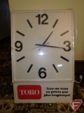 Toro lighted advertising clock with spanish phrase 