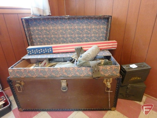 Trunk with ammo boxes and military uniforms, flag