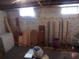 Homemade coat racks, nail barrel, shelves, rough sawn wood table top, and misc. lumber