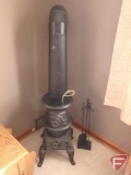 Cast iron potbelly stove with fireplace utensils