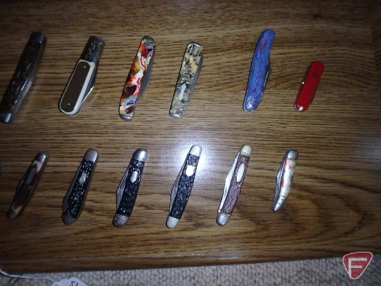 Pocket knives, some advertising - Texaco, Trojan. Contents of shelf.