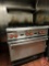 Wolf 6-Burner gas range with oven and top shelf on casters