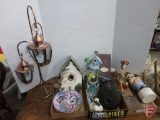 Birdhouses, plates, battery operated lanterns on metal stand