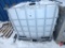 250 Gallon poly tank with bottom mounted valve in caged pallet