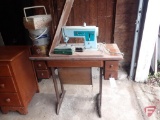 Singer sewing machine on table , with accessories