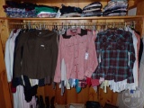 LADIES WESTERN SHIRTS AND SWEATERS. ALL HANGING IN CLOSET