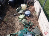 Contents of garden enclosure; trash cans with lids, plastic watering cans, 5 gallon pails