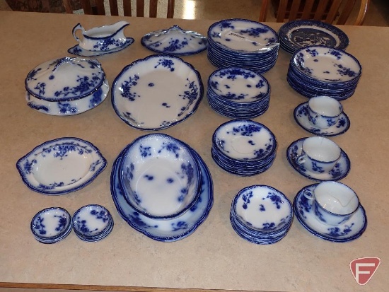 Flo Blue dishes with some Blue Willow, some pieces have chips and cracks, all on counter