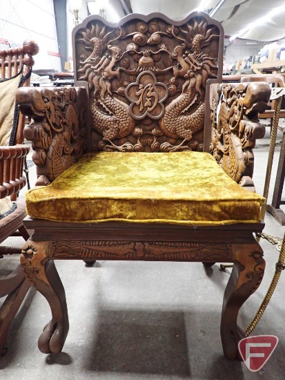 Vintage unique chair with ornate dragon carvings and seat cushion