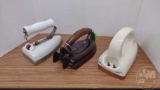 (3) VINTAGE ELECTRIC IRONS WITHOUT CORDS, (1) RIVAL WITH WOODEN